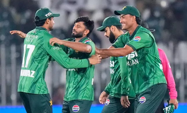 Pakistan's Muhammad Imran, second left, celebrates with teammates after taking the wicket of Sri Lanka's Kamil Mishara during the first T20 cricket match between Pakistan and Sri Lanka, in Rawalpindi, Pakistan, Friday, Oct. 9, 2026. (AP Photo/Anjum Naveed)