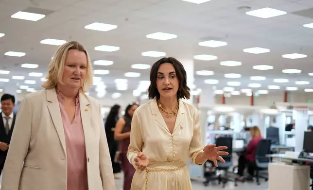 Pandora CEO Berta de Pablos-Barbier, right, speaks with Danish Ambassador to Vietnam Lina Gandlose Hansen as they visit the factory in Ho Chi Minh city, Vietnam, Thursday, Oct.1, 2026. (AP Photo/Hau Dinh)