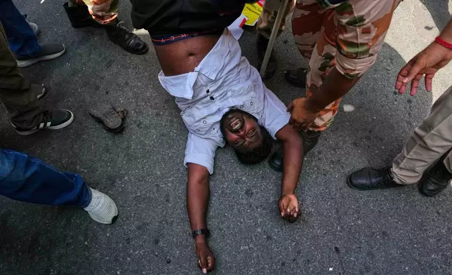 Socialist, left-wing parties and student activists shout slogans as police detain them during a protest against Chief Election Commissioner Gyanesh Kumar and calling for the suspension of the Special Intensive Revision (SIR) of electoral rolls in New Delhi, India, Friday, Oct. 2, 2026. (AP Photo/Manish Swarup)