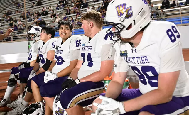 Players from Whittier College take a break during an NCAA Division III college game against Azusa Pacific, Sept. 19, 2026, in Glendora, Calif. (AP Photo/Wally Skalij)