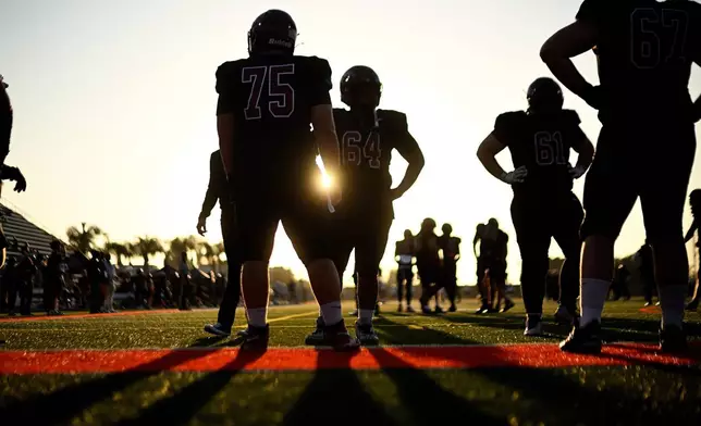 Players from Azusa Pacific warm up before an NCAA Division III college football game against Whittier College, Sept. 19, 2026, in Glendora, Calif. (AP Photo/Wally Skalij)