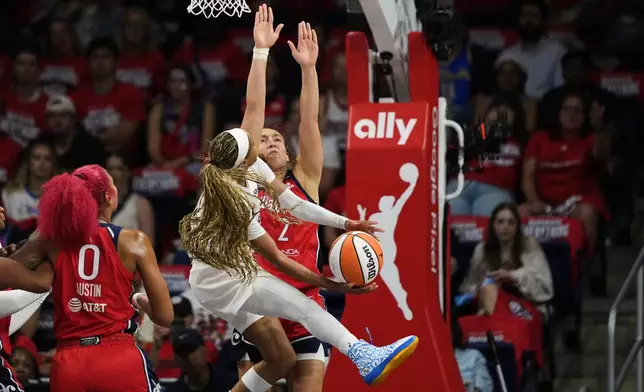 Atlanta Dream guard Matilde Villa, center, is fouled against by Washington Mystics guard Alicia Florez (2) during the first half in Game 2 of a WNBA basketball first-round playoff series, Wednesday, Sept. 30, 2026, in Washington. (AP Photo/Stephanie Scarbrough)