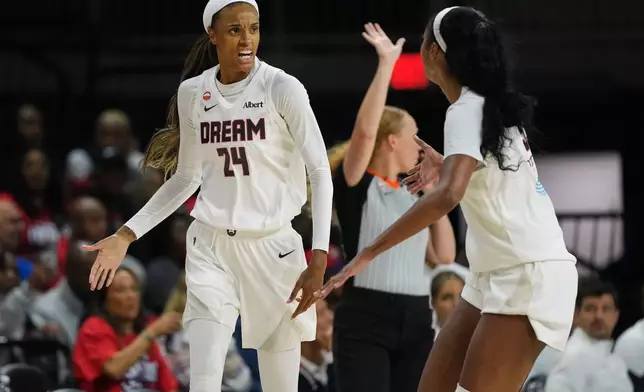 Atlanta Dream forward DeWanna Bonner (24) celebrates with forward Angel Reese, right, after making a three-point basket against the Washington Mystics during the first half in Game 2 of a WNBA basketball first-round playoff series, Wednesday, Sept. 30, 2026, in Washington. (AP Photo/Stephanie Scarbrough)