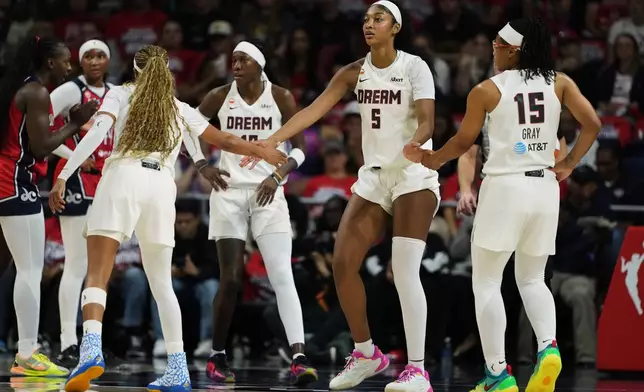 Atlanta Dream forward Angel Reese (5) celebrates with teammates after being fouled against during the first half in Game 2 of a WNBA basketball first-round playoff series against the Washington Mystics, Wednesday, Sept. 30, 2026, in Washington. (AP Photo/Stephanie Scarbrough)