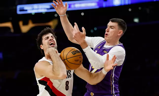 Portland Trail Blazers forward Deni Avdija (8), left, loses control of the ball while being guarded by Los Angeles Lakers forward Jake LaRavia (12), right, during the first half of an NBA basketball game Tuesday, Oct. 27, 2026, in Los Angeles. (AP Photo/Caroline Brehman)