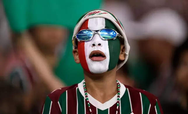 A fan of Brazil's Fluminense waits for the start of the first leg of a Copa Libertadores semifinal soccer match between Brazil's Fluminense and Brazil's Palmeiras in Rio de Janeiro, Wednesday, Oct. 14, 2026. (AP Photo/Bruna Prado)