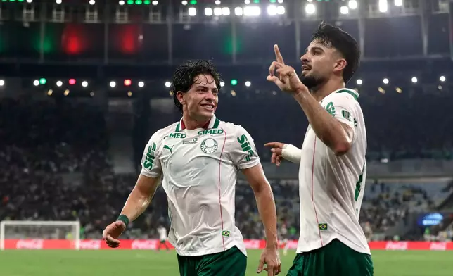 Flaco Lopez of Brazil's Palmeiras, right, celebrates with teammate Agustin Giay after scoring his side's opening goal against Brazil's Fluminense during the first leg of a Copa Libertadores semifinal soccer match in Rio de Janeiro, Wednesday, Oct. 14, 2026. (AP Photo/Bruna Prado)
