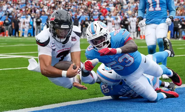 Houston Texans quarterback C.J. Stroud (7) dives into the end zone for a touchdown after running the ball past Tennessee Titans safety Tony Adams (29) and Anthony Hill Jr. (53) during the second half of an NFL football game in Nashville, Tenn., Sunday, Oct. 11, 2026. (AP Photo/George Walker IV)