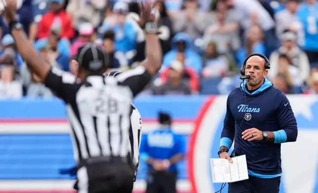 Tennessee Titans head coach Robert Saleh, right, calls for a time out as field judge Sean Petty (28) responds during the first half of an NFL football game against the Houston Texans in Nashville, Tenn., Sunday, Oct. 11, 2026. (AP Photo/George Walker IV)