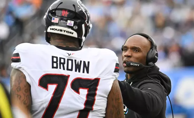 Houston Texans head coach DeMeco Ryans, right, talks with offensive tackle Trent Brown (77) on the sideline during the first half of an NFL football game against the Tennessee Titans in Nashville, Tenn., Sunday, Oct. 11, 2026. (AP Photo/John Amis)