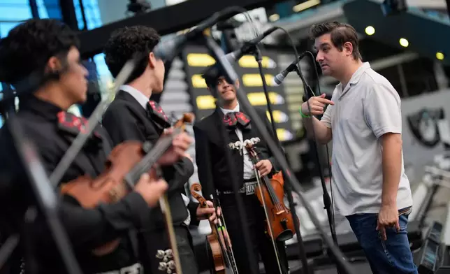 Stephen Blanco, the mariachi chair at the University of Nevada, Las Vegas, speaks with his students before a performance at a UNLV football game Saturday, Oct. 3, 2026, in Las Vegas. (AP Photo/John Locher)