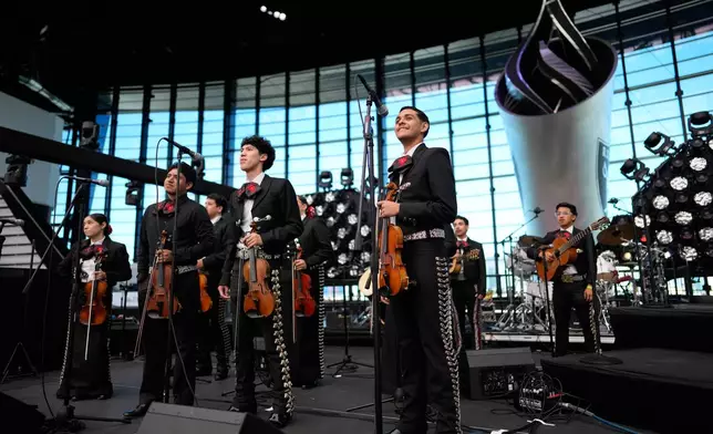 From left, Brenda Guzman, Mario Paisano, Blanier Bojorquez and Axel Rodríguez Olivas prepare to perform with other University of Nevada, Las Vegas mariachi students at a football game Saturday, Oct. 3, 2026, in Las Vegas. (AP Photo/John Locher)