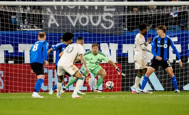 Atlanta United's Miguel Almiron (10) scores on CF Montreal goalkeeper Sebastian Breza during the first half of a MLS soccer game, in Montreal, Wednesday, Oct. 14, 2026. (Christopher Katsarov/The Canadian Press via AP)