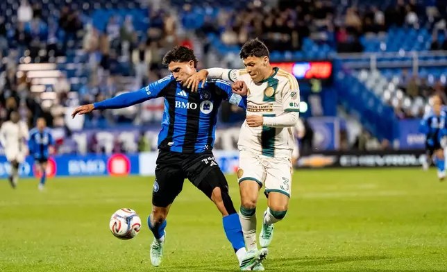 CF Montreal's Daniel Rios, left, and Atlanta United's Elias Baez (3) vie for possession of the ball during the first half of a MLS soccer game, in Montreal, Wednesday, Oct. 14, 2026. (Christopher Katsarov/The Canadian Press via AP)