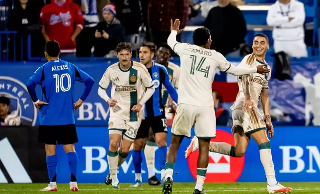 Atlanta United's Miguel Almiron (right) celebrates his goal against CF Montreal with teammates during the first half of a MLS soccer game, in Montreal, Wednesday, Oct. 14, 2026. (Christopher Katsarov/The Canadian Press via AP)