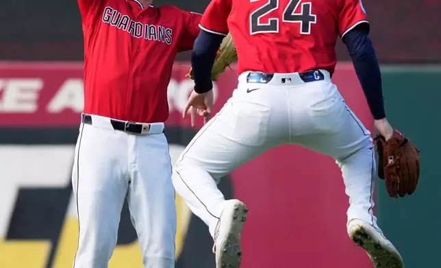 Cleveland Guardians center fielder Petey Halpin and right fielder Chase DeLauter celebrate after Game 3 of an American League Championship Series baseball game against the Tampa Bay Rays in Cleveland, Thursday, Oct. 15, 2026. (AP Photo/David J. Phillip)