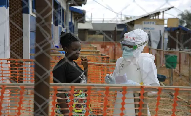 A healthcare worker speaks to Ebola patients inside a treatment center in Beni, North Kivu province, eastern Congo, Saturday, Sept. 26, 2026. (AP Photo/Sebastien Kitsa Musayi)
