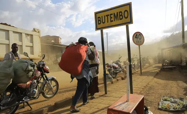 People walk along a street in Butembo, Congo, Wednesday, Sept. 30, 2026. (AP Photo/Sebastien Kitsa Musayi)