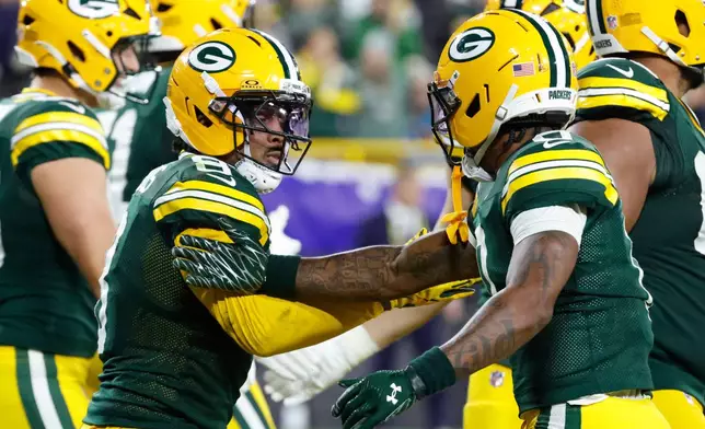 Green Bay Packers running back Josh Jacobs, left, celebrates after scoring a touchdown with wide receiver Matthew Golden, right, during the second half of an NFL football game in Green Bay, Wis., Thursday, Oct. 29, 2026. (AP Photo/Mike Roemer)