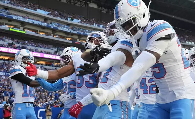 Tennessee Titans safety Amani Hooker, second from right, celebrates his interception with teammates during the first half of an NFL football game against the Indianapolis Colts, Sunday, Oct. 18, 2026, in Indianapolis. (AP Photo/Jeff Roberson)