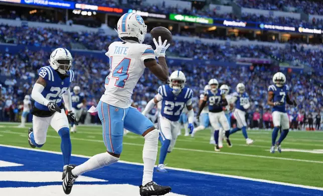 Tennessee Titans wide receiver Chimere Dike (17) catches a touchdown pass in the end zone during the second half of an NFL football game against the Indianapolis Colts, Sunday, Oct. 18, 2026, in Indianapolis. (AP Photo/Jeff Roberson)