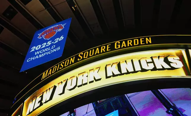 The New York Knicks 2025-26 World Champions banner is raised before an NBA basketball game between the Knicks and the Philadelphia 76ers Tuesday, Oct. 20, 2026, in New York. (AP Photo/Frank Franklin II)