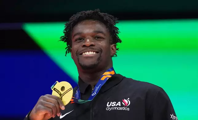 Frederick Richard, of the United States, poses on the podium after winning the gold medal in the floor exercise during the apparatus finals at the Artistic Gymnastics World Championships in Rotterdam, the Netherlands, Saturday, Oct. 24, 2026. (AP Photo/Francisco Seco)