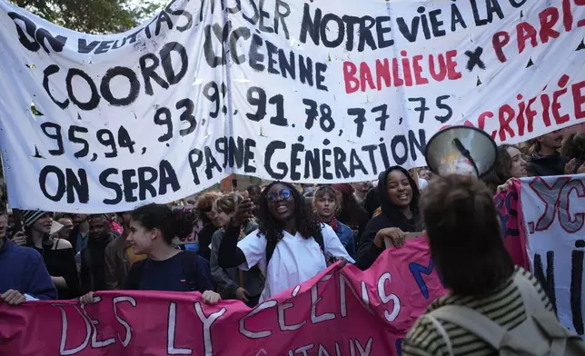 Protesters march during a demonstration against rising living costs, joining students' grievances, in Paris, Saturday, Oct. 17, 2026. (AP Photo/Thibault Camus)