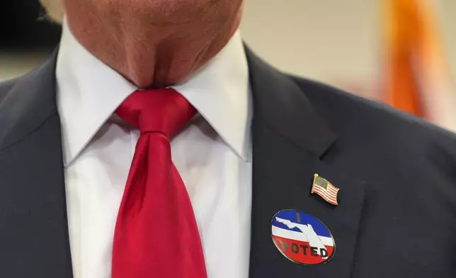 President Donald Trump wears an I Voted sticker as he speaks after voting at the Palm Beach County Library in West Palm Beach, Fla., Saturday, Oct. 24, 2026. (AP Photo/Mark Schiefelbein)