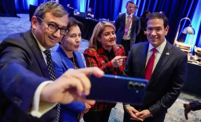 Secretary of State Marco Rubio participates in a selfie during the G20 Foreign Ministers Meeting Welcome Reception at the Georgia Aquarium in Atlanta, Friday, Oct. 30, 2026. (Megan Varner/Pool Photo via AP)