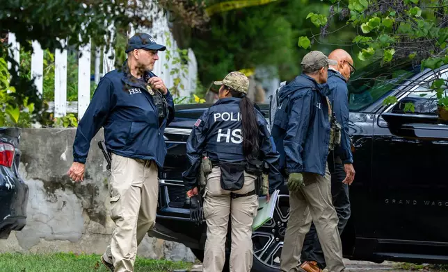 Homeland Security officers leave the Washington residence of Rep. Ilhan Omar, D-Minn., after a search, Monday, Oct. 12, 2026. (AP Photo/J. Scott Applewhite)