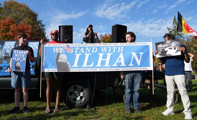 Community members rally in support of Democratic Rep. Ilhan Omar, D-Minn., Monday, Oct. 12, 2026, at Powderhorn Park in Minneapolis. (AP Photo/Ellen Schmidt)