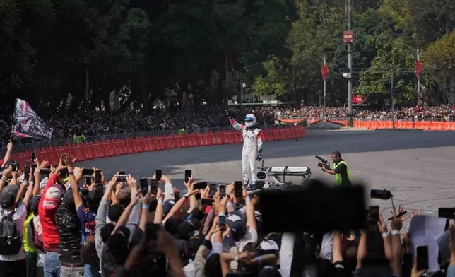 Mexican driver Sergio Perez of the Cadillac F1 Team waves after driving along Paseo de la Reforma during an exhibition in Mexico City, Wednesday, Oct. 28, 2026. (AP Photo/Eduarto Verdugo)