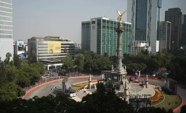 Mexican driver Sergio Perez of the Cadillac F1 Team drives along Paseo de la Reforma during an exhibition in Mexico City, Wednesday, Oct. 28, 2026. (AP Photo/Leslie Mazoch)