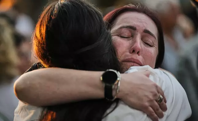 People attend a memorial service marking the third anniversary of the Oct. 7, 2023, Hamas cross-border attack on Israel, in Kibbutz Kfar Aza, southern Israel, where many community members were killed and abducted, Wednesday, Oct. 7, 2026. (AP Photo/Ariel Schalit)