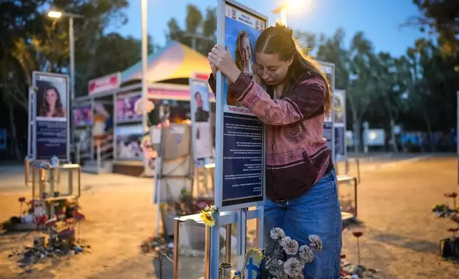 Raz Zarfati, sister of Ron Zarfati who was killed in the Oct. 7, 2023, Hamas attack on Israel, attend a memorial marking the third anniversary of the attack at the Nova music festival site near Kibbutz Reim, southern Israel, Wednesday, Oct. 7, 2026. (AP Photo/Ohad Zwigenberg)