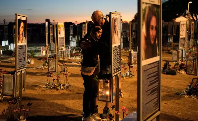 Benny and Maggy Solomon, parents of Hila Solomon, who was killed in the Oct. 7, 2023, Hamas attack on Israel, attend a memorial marking the third anniversary of the attack at the Nova music festival site near Kibbutz Reim, southern Israel, Wednesday, Oct. 7, 2026. (AP Photo/Ohad Zwigenberg)