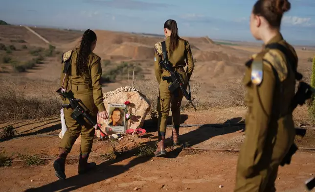 Israeli soldiers attend a memorial service marking the third anniversary of the Oct. 7, 2023, Hamas cross-border attack on Israel, near Kibbutz Nahal Oz, southern Israel, where female observer soldiers were killed, Wednesday, Oct. 7, 2026. (AP Photo/Ariel Schalit)