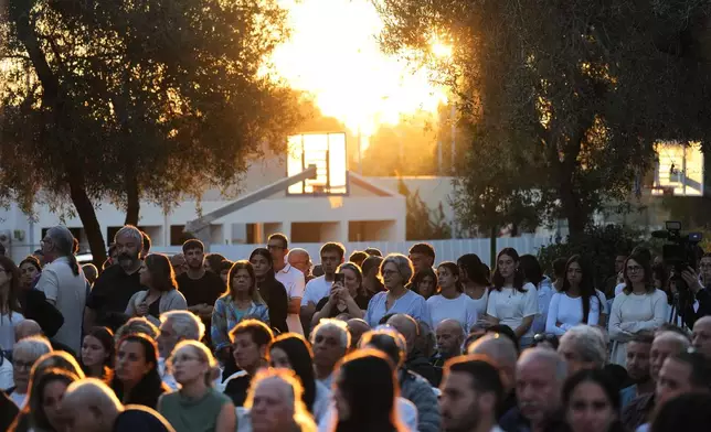 People attend a memorial service marking the third anniversary of the Oct. 7, 2023, Hamas cross-border attack on Israel, in Kibbutz Kfar Aza, southern Israel, where many community members were killed and abducted, Wednesday, Oct. 7, 2026. (AP Photo/Ariel Schalit)