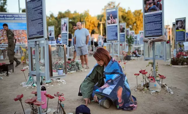 People mark the third anniversary of the Oct. 7, 2023, Hamas attack on Israel at the site of the Nova music festival, where hundreds of revelers were killed and abducted, near Kibbutz Reim, southern Israel, Wednesday, Oct. 7, 2026. (AP Photo/Ohad Zwigenberg)