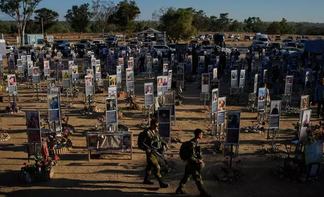 Israeli soldiers and civilians mark the third anniversary of the Oct. 7, 2023, Hamas attack on Israel at the site of the Nova music festival, where hundreds of revelers were killed and abducted, near Kibbutz Reim, southern Israel, Wednesday, Oct. 7, 2026. (AP Photo/Ohad Zwigenberg)