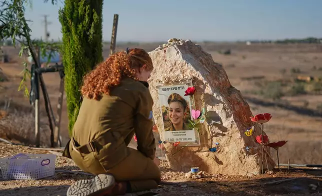 An Israeli soldier attends a memorial service marking the third anniversary of the Oct. 7, 2023, Hamas cross-border attack on Israel, near Kibbutz Nahal Oz, southern Israel, where female observer soldiers were killed, Wednesday, Oct. 7, 2026. (AP Photo/Ariel Schalit)