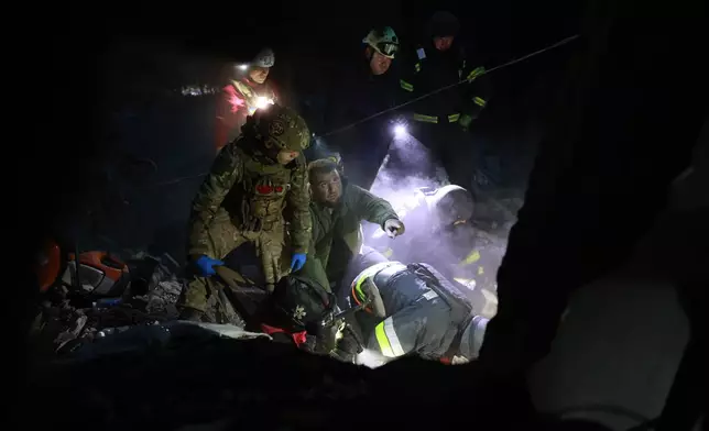 Rescue workers clear the rubble of a residential building destroyed by a Russian airstrike in Zaporizhzhia, Ukraine, Saturday, Oct. 10, 2026. (AP Photo/Kateryna Klochko)