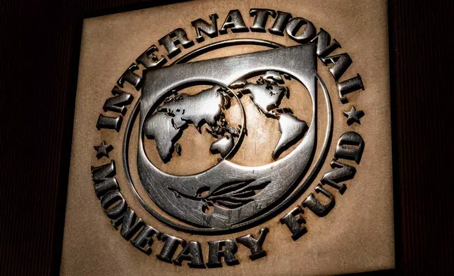 FILE - The logo of the International Monetary Fund is visible on its building, April 5, 2021, in Washington. (AP Photo/Andrew Harnik, File)