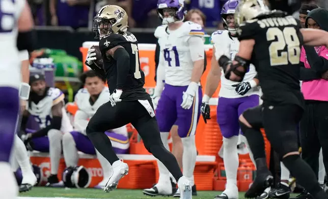 New Orleans Saints safety Jonas Sanker (7) runs toward the end zone as he returns a fumble recovery for a touchdown during the second half of an NFL football game against the Minnesota Vikings in New Orleans, Sunday, Oct. 11, 2026. (AP Photo/Gerald Herbert)