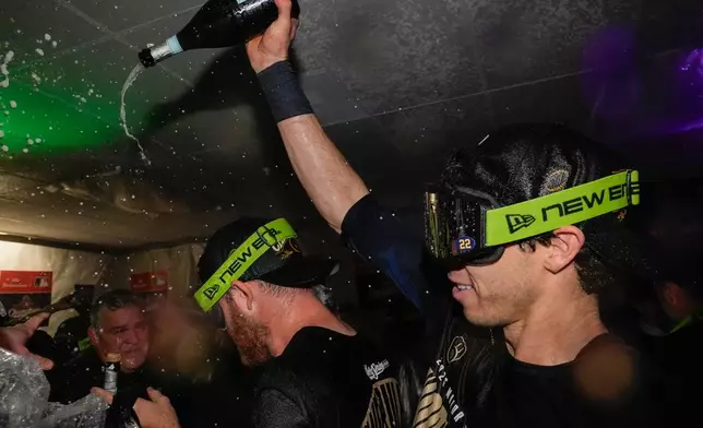 Milwaukee Brewers designated hitter Christian Yelich, right, celebrates with teammates after winning baseball's World Series, against the Tampa Bay Rays, Wednesday, Oct. 28, 2026, in St. Petersburg, Fla. (AP Photo/Chris O'Meara)