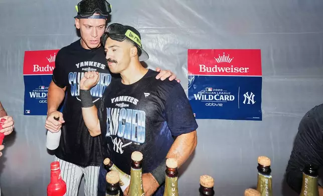 New York Yankees' Aaron Judge, left, and Trent Grisham, right, celebrate after winning baseball's American League Wild Card Series against the Boston Red Sox in Game 2, Wednesday, Sept. 30, 2026, in New York. (AP Photo/Frank Franklin II)