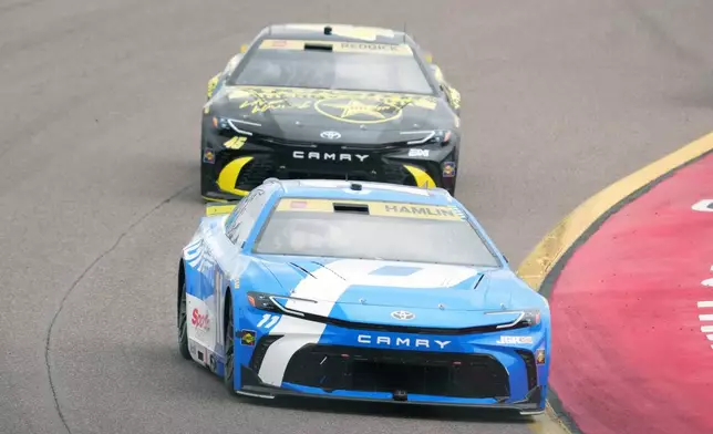 Denny Hamlin (11) leads Tyler Reddick on the 30th lap during a NASCAR Cup Series auto race Sunday, Oct. 18, 2026, in Avondale, Ariz. (AP Photo/Rick Scuteri)