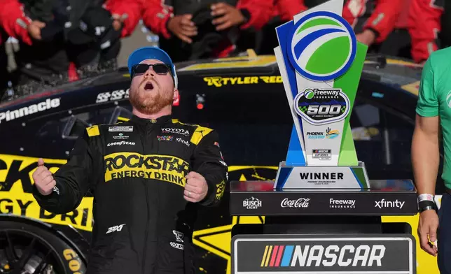 Tyler Reddick celebrates after winning a NASCAR Cup Series auto race Sunday, Oct. 18, 2026, in Avondale, Ariz. (AP Photo/Rick Scuteri)
