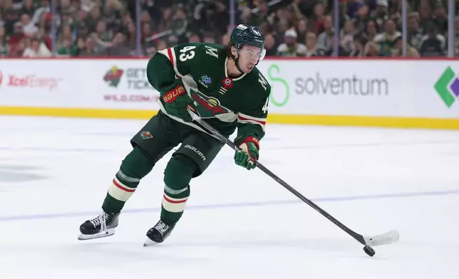 Minnesota Wild defenseman Quinn Hughes skates with the puck during the first period of an NHL hockey game against the Boston Bruins, Saturday, Oct. 3, 2026, in St. Paul, Minn. (AP Photo/Bailey Hillesheim)